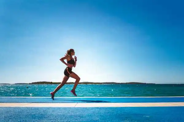 Woman running showing strong leg muscle Milngavie